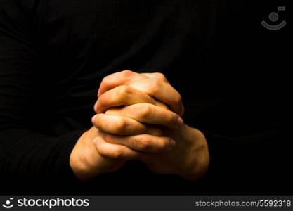 Young man&rsquo;s hands in prayer