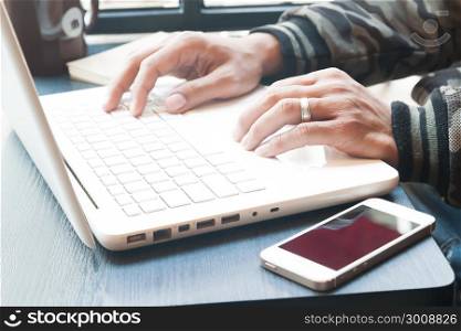 Young man&rsquo;s hands using laptop in cafe, Social network or online shopping