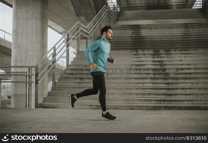 Young man running fast outdoors in the city