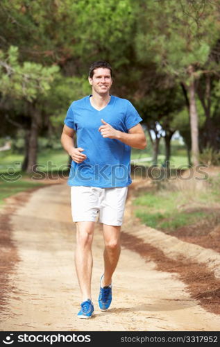 Young man running in park