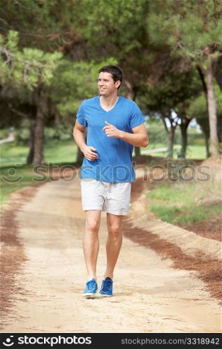 Young man running in park
