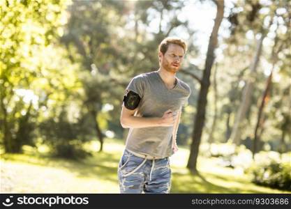 Young man running in the autumn park