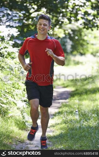 Young Man Running Outdoors In Countryside