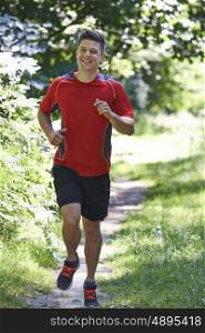 Young Man Running Outdoors In Countryside