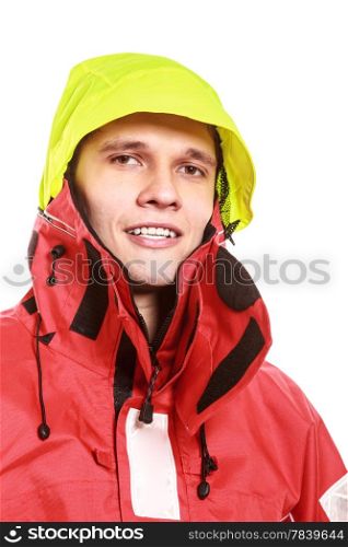Young man sailor wearing red waterproof wind jacket and yellow hood isolated on white. Sailing yachting cruise. Studio shot.