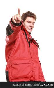 Young man sailor wearing red waterproof wind jacket showing pointing at you isolated on white. Sailing yachting cruise. Studio shot.