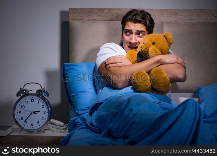 Young man scared in bed