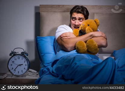 Young man scared in bed