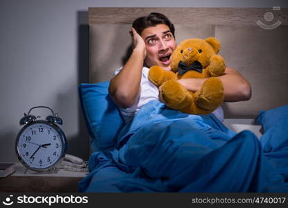 Young man scared in bed