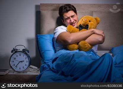 Young man scared in bed