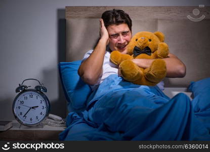 Young man scared in bed