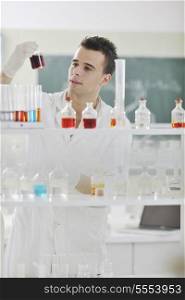 young man scientist in chemistry bright lab