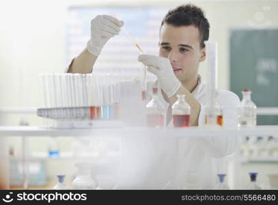 young man scientist in chemistry bright lab