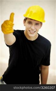 young man, selective focus on eye, black t-shirt and yellow helmet great for your design or text