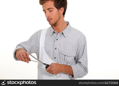 Young man sharpening knife