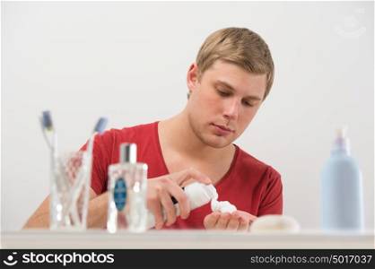 Young man shaving at home