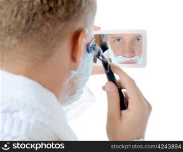Young man shaving in the morning close-up. Isolated on a white background
