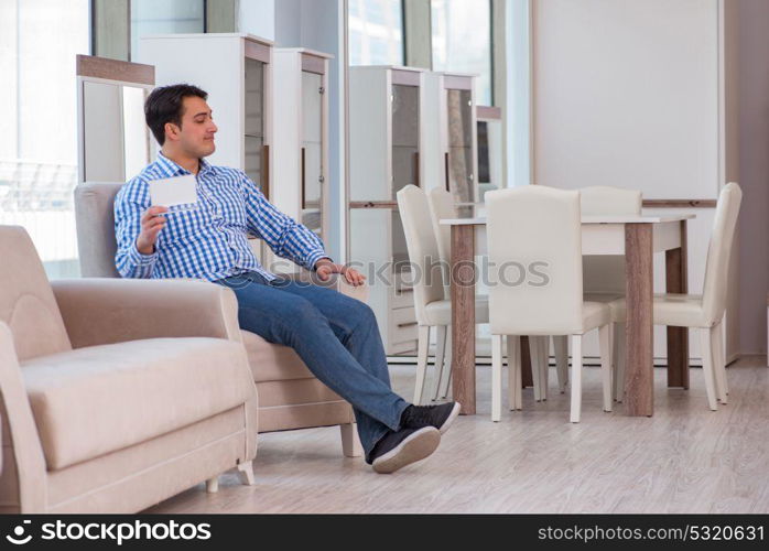 Young man shopping in furniture store