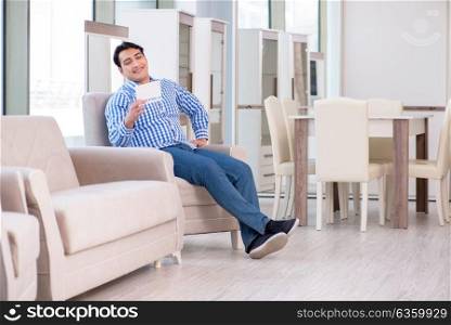 Young man shopping in furniture store