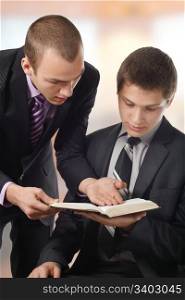 Young man showing a truth in the Bible, to another young man