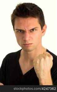 Young man showing fist and looking very aggressive