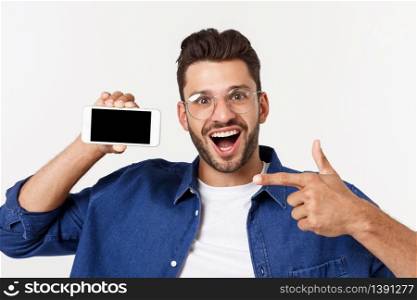 Young man showing his brand new smart phone isolated on white. Young man showing his brand new smart phone isolated on white.