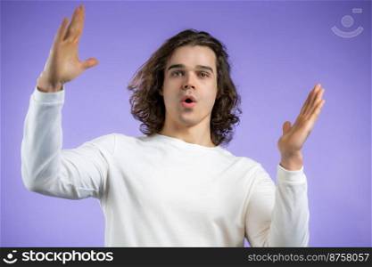 Young man showing invisible abstract big subject or object. Large concept. High quality photo. Young man showing invisible abstract big subject or object. Large concept.