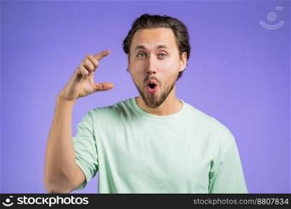 Young man showing invisible abstract big subject or object. Large concept. High quality photo. Young man showing invisible abstract big subject or object. Large concept.