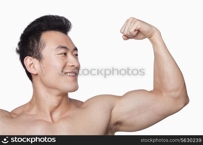 Young man showing off bicep