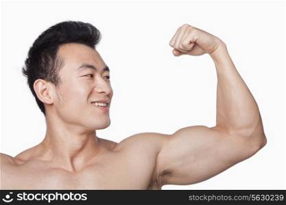 Young man showing off bicep