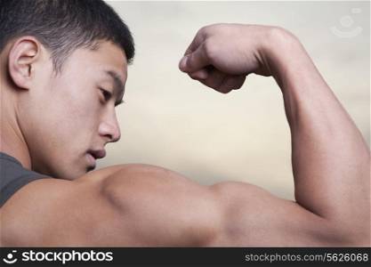 Young Man showing off his bicep muscles