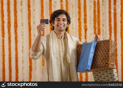 Young man showing off his shopping that he did with his Credit card