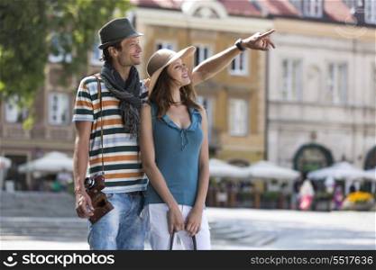 Young man showing something to woman during vacation