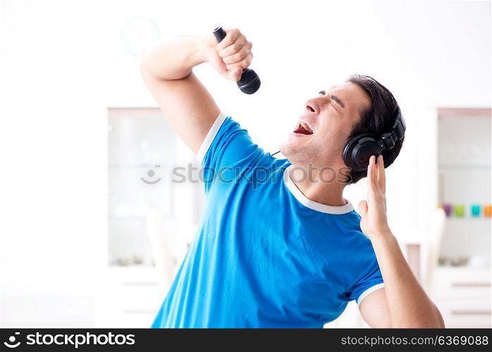 Young man singing at home karaoke