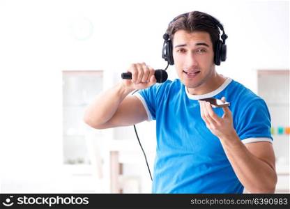 Young man singing at home karaoke