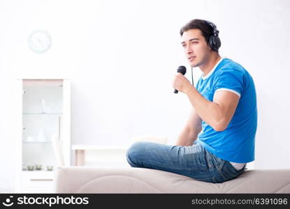 Young man singing at home karaoke