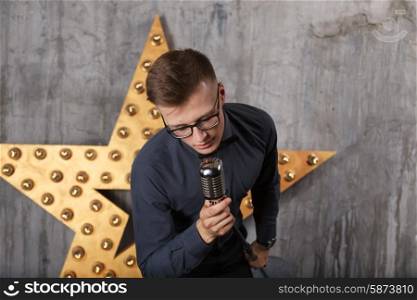 Young man singing with vintage microphone&#xA;