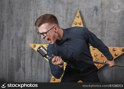 Young man singing with vintage microphone&#xA;