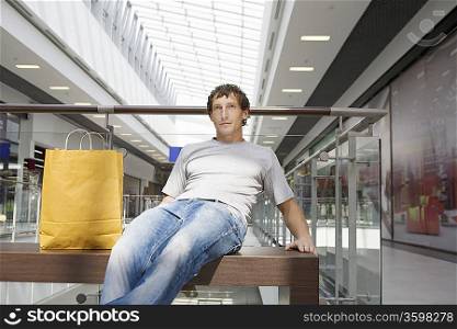 Young man sits in new shopping centre Voronezh