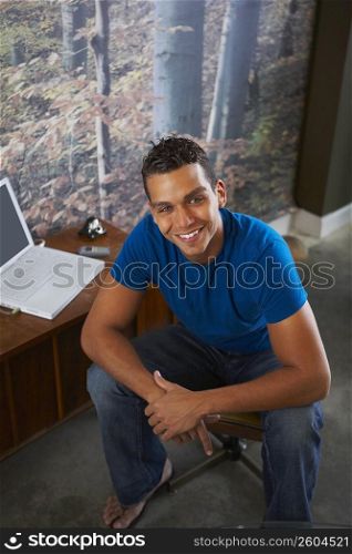 Young man sitting and smiling