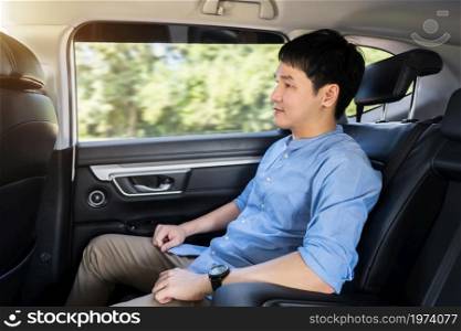 young man sitting at the back seat of car