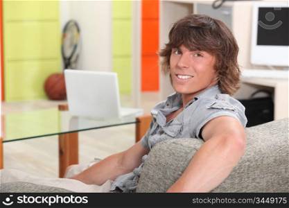 Young man sitting in a recreation room at college