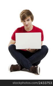 Young man sitting in the floor and working with a laptop. Man working with a laptop