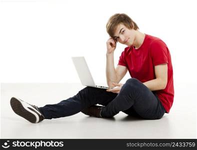 Young man sitting in the floor and working with a laptop