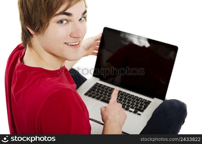 Young man sitting in the floor and working with a laptop