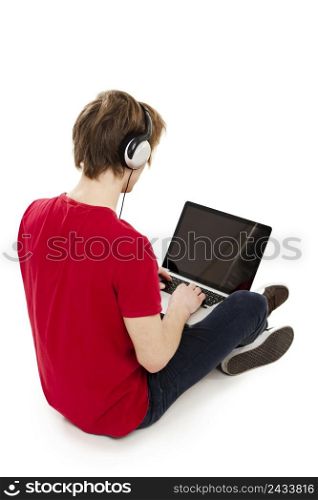 Young man sitting in the floor playing computer games