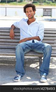 Young man sitting on bench