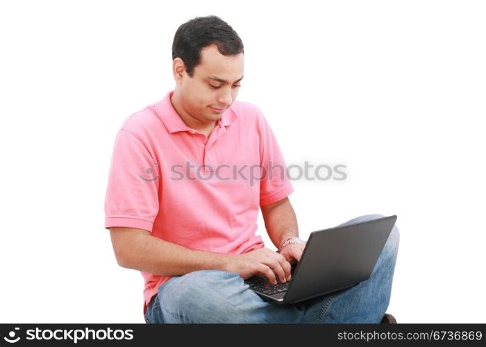 Young man sitting on the floor and work with laptop computer