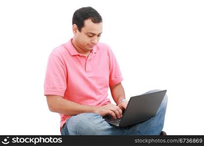 Young man sitting on the floor and work with laptop computer