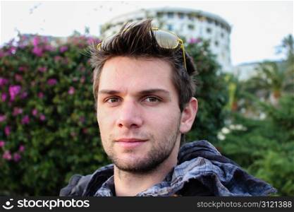 Young Man Sitting Outdoors And Thinking